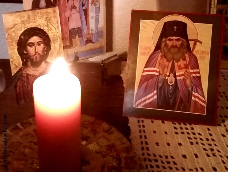 Icons of St. John Maximovitch and Christ with a burning candle