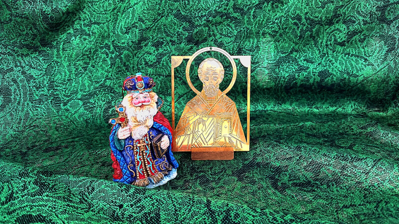 Small brass icon of St. Nicholas next to a colorful figurine of the saint.